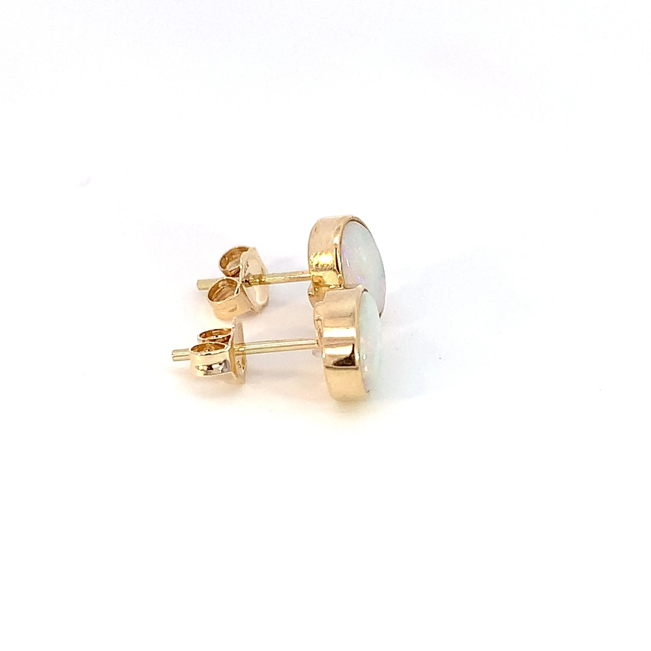 One pair of 9kt Yellow Gold Light Opal earring studs 7x5mm bezel set